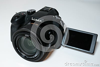 Panasonic Lumix FZ1000 Digital Camera on white desk with flip out screen. Editorial Stock Photo