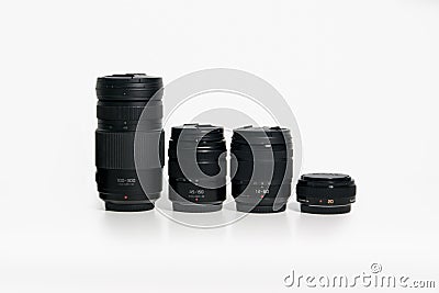 Panasonic Lumix Micro Four Thirds camera lenses on a white desk Editorial Stock Photo