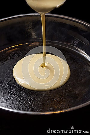 Pancake batters pouring in pan Stock Photo