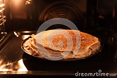 Pancake cake is baked in an oven Stock Photo