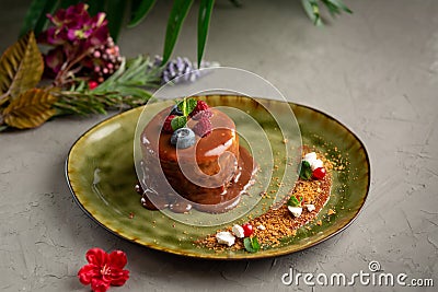 Pancake with melted chocolate and berries on a grey background Stock Photo