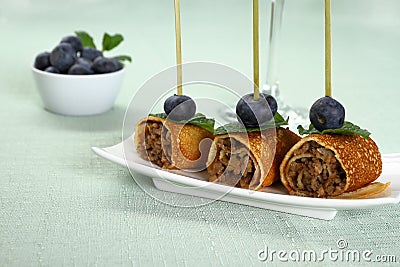 Pancake roll stuffed with minced meat as snack Stock Photo