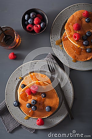 Pancakes with blueberry raspberry honey and jam for breakfast Stock Photo