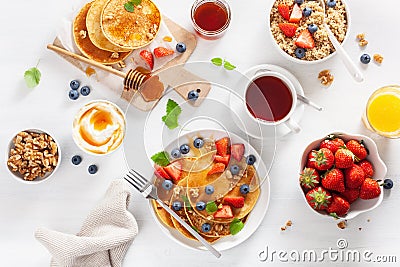 pancakes with blueberry strawberry honey and quinoa for breakfast Stock Photo