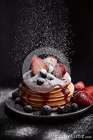 Pancakes close up, with fresh strawberry, blueberries, mint and jam Stock Photo