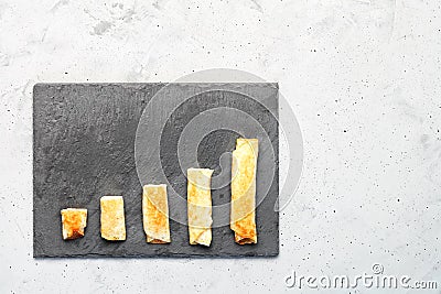 Pancakes with cottage cheese on a gray slate are arranged in the form of a growing trend Stock Photo