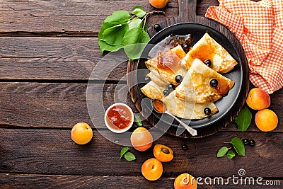 Pancakes with fresh blackcurrant and apricot jam Stock Photo