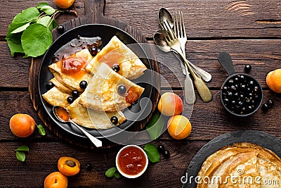 Pancakes with fresh blackcurrant and apricot jam Stock Photo