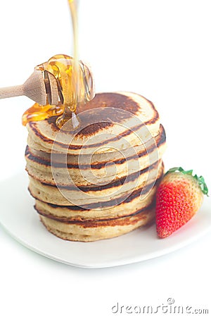 Pancakes, honey, strawberry and stick to honey Stock Photo