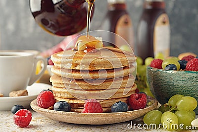 Pancakes with maple syrup and berries Stock Photo