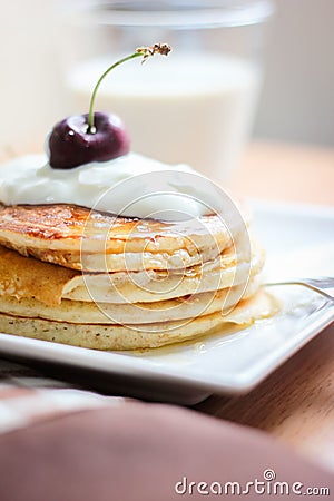 Breakfast whole wheat pancakes with cherry and yogurt Stock Photo
