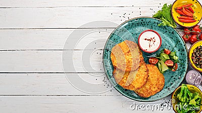 Pancakes with potatoes with sour cream. Stock Photo