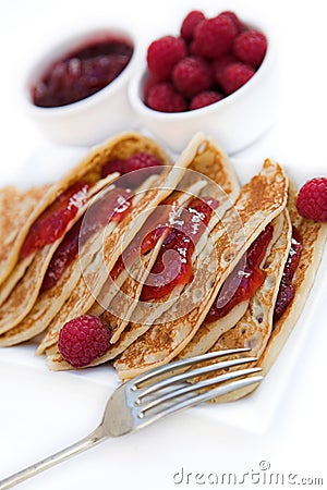 Pancakes with raspberry jam & fresh raspberries Stock Photo