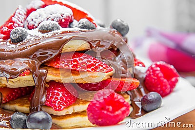 Dish with pancakes and strawberry,raspberry and blueberry and chocolate Stock Photo