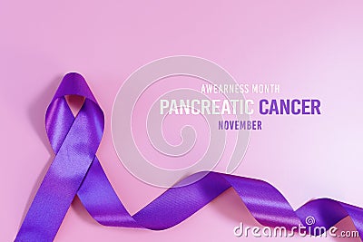 Pancreatic Cancer Awareness Ribbon, purple ribbons on light pink background Stock Photo