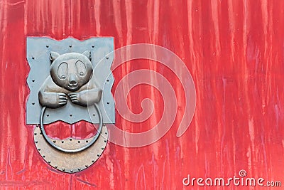 Panda chinese door knocker on a red gate Stock Photo
