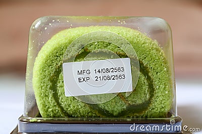 Pandan flavor roll cake in package with expiry date tag Stock Photo