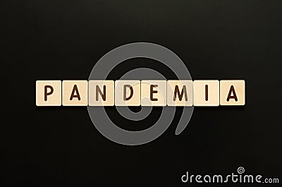 PANDEMIA - word from wooden blocks with letters. Top view on black background. Stock Photo