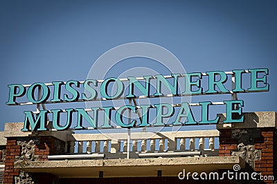 Panel of a building or it is written on it in French `municipal fish market` Editorial Stock Photo