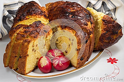 Panettone whith raisins and Easter eggs on white porcelain platte Stock Photo