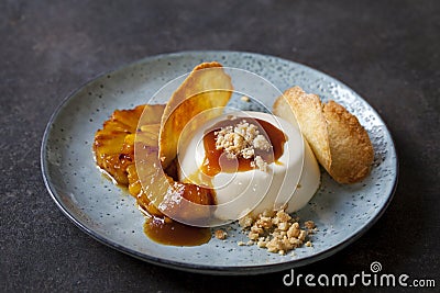 Panna cotta with caramelised pineapple and coconut biscuit Stock Photo