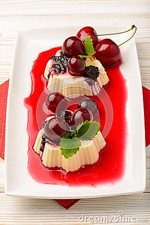 Panna cotta with cherries and cherry sauce. Stock Photo