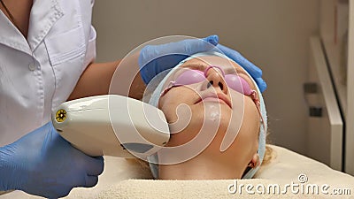 Panning up shot of doctor or therapist administering fractional skin laser treatment to resurface and rejuvenate a Stock Photo