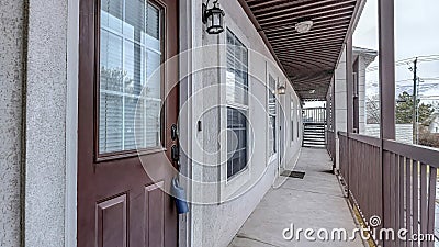 Pano Apartment units with single loaded corridor access overlooking the neighborhood Stock Photo