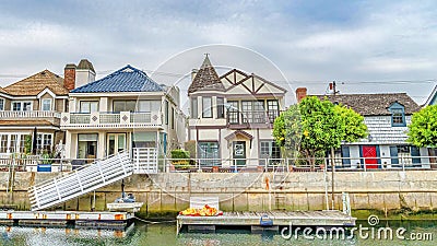 Pano Elegant houses overlooking public canal with walkways in Long Beach California Stock Photo