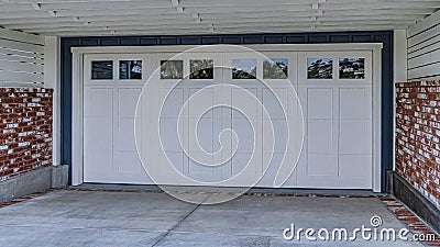 Pano White garage door under spacious balcony with white railing in San Diego CA Stock Photo