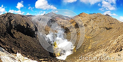 Panorama of Active Bromo volcano mountain crater hole erupt with sulfur gas and smoke at Indonesia Bromo national park Stock Photo