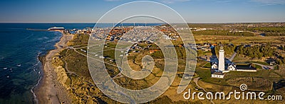 Panorama aerial of lighthouse Hirtshals Fyr with campers and vans parked nearby on the sandy beach and Hirtshals Stock Photo