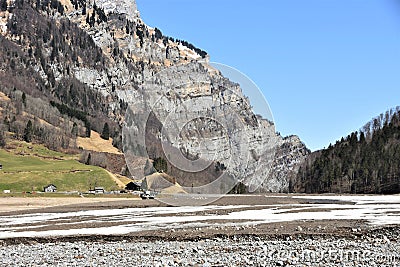 Panorama of Alps from the bottom of partly dried-up KlÃ¶ntalersee lake covered with snow and ice Stock Photo