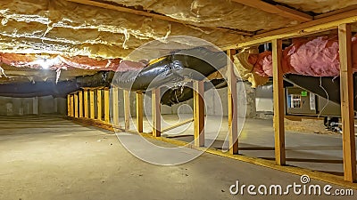 Panorama Basement or crawl space with upper floor insulation and wooden support beams Stock Photo