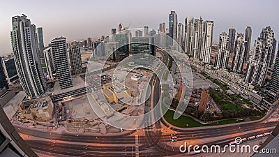 Bay Avenue with modern towers residential development in Business Bay aerial panoramic night to day timelapse, Dubai Editorial Stock Photo