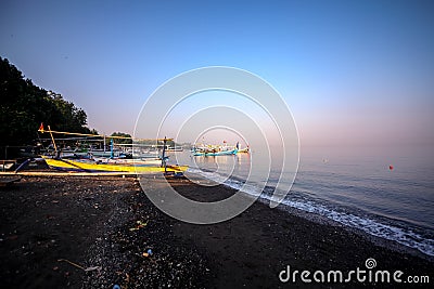 Panorama of a beach with boats and volcanic black sand in the North of Bali Editorial Stock Photo