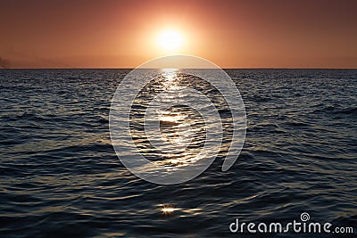 Panorama of beautiful sunset on sea. Bright horizon landscape over water. Dramatic sunset with twilight color sky and waves of sea Stock Photo