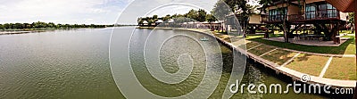 Panorama of Bung Chawak Resort lake and tree Houses Stock Photo