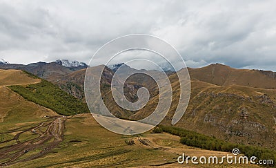 Panorama of Caucasian mountains near Gergeti Trinity Church, village of Gergeti and Stepancminda in Georgia. Stock Photo