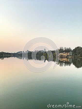 Panorama of the city park. Reflection of tall buildings in the lake. Stock Photo