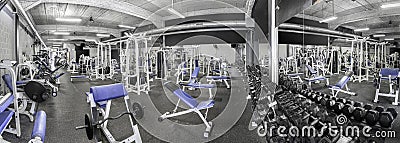 Panorama of a classic bright gym. White sport equipment and blue seats Stock Photo