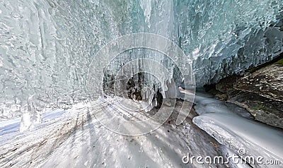 Panorama dawn in an ice cave with icicles on Baikal, Olkhon Stock Photo