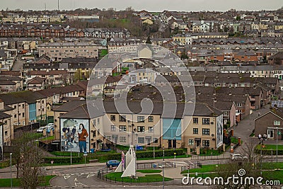 Panorama of Derry or Londonderry on a cloudy day viewed from the city walls. Green panorama of the city, residental houses visible Stock Photo