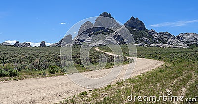 Panorama of a dirt road leading to granite outcroppings at the City of Rocks National Reserve, Idaho, USA Stock Photo