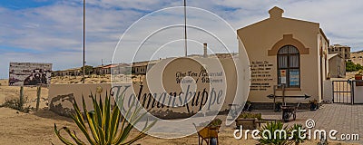 Panorama Entrance of Kolmanskop Ghost Town in Namibia with the sign Kolmanskuppe in german language Editorial Stock Photo