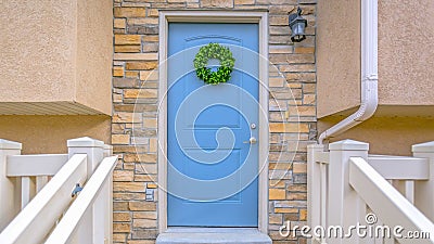 Panorama Entryway of a home with stairs leading to the porch and blue front door Stock Photo