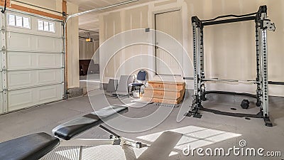 Panorama frame Assorted gym and fitness equipment in a garage Stock Photo