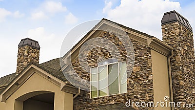 Panorama frame Exterior of a splendid house with a combination of stone and conrete wall. Stock Photo