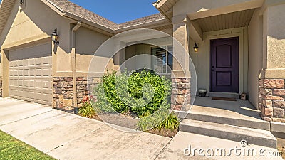 Panorama frame Facade of home with gable roofs over the entrance and garage against blue sky Stock Photo