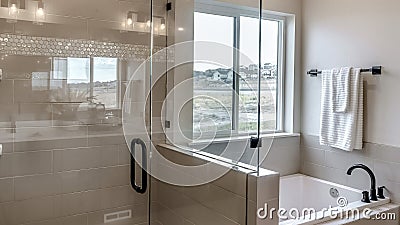 Panorama frame Frameless walk in shower stall and built in bathtub inside tile wall bathroom Stock Photo